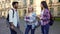 Cheerful hispanic male talking with girls near college, break, friendship