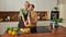 Cheerful homosexual male couple hugging in kitchen