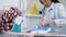 Cheerful housewife in good mood ironing t-shirt, enjoying domestic work, closeup