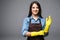 Cheerful housewife putting on gloves before cleaning