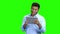 Cheerful Indian man with tablet pc on green screen.