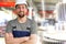 Cheerful industrial worker in a factory in work clothes to repair machines and equipment