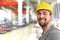 Cheerful industrial worker in a factory in work clothes to repair machines and equipment