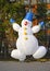 Cheerful inflatable snowman. Christmas decoration on the street