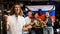 Cheerful international soccer football fans waving Russian flag and drinking beer, eating chips in the sport bar