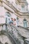 Cheerful just married couple in love posing on ancient stairs at the old austrian palace