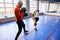 Cheerful kid enjoying fighting with coach at gym