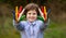 Cheerful kid girl show hello gesture with hands painted in Seychelles flag colors. Focus on hands