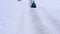 Cheerful kid rides on sled with snow slides. child having fun at winter holidays. Slow motion