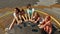 Cheerful kids on rotating swing with smartphones