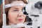 Cheerful lady having eye examination in oculist office