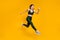 Cheerful lady jump high jogging marathon speed race competitive person wear sports suit shoes isolated yellow color