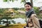 Cheerful lady pointing to deer garden temple