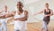 Cheerful Latino practicing vigorous dance in group class