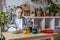 Cheerful little boy paints eggs with food coloring. Easter holiday. Rainbow color