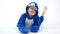 Cheerful little boy posing on a white background in pajamas kigurumi, blue shark costume