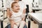 Cheerful little child with mom at ophthalmologist appointment