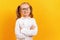 Cheerful little girl in glasses on a yellow color background.