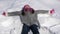 Cheerful little girl making snow angel