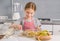 Cheerful little girl mixing ingredients for strudel filling