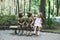 Cheerful little girl playing with park statues