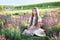 Cheerful Little girl relax on picnic on lavender field. Provence, France. Girl child collect lavender. beautiful young girl with s