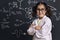 Cheerful little girl science student in lab coat