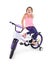 Cheerful little girl on a sports bike on a white background