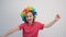 Cheerful little girl wearing rainbow wig