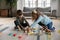 Cheerful little kids sibling playing toys at home.