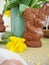 Cheerful looking chocolate easter bunny on a table with yellow daffodil flower