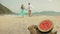 The cheerful love couple in blur, against the background of a watermelon on tropical sand beach sea. Romantic lovers two