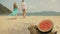 The cheerful love couple in blur, against the background of a watermelon on tropical sand beach sea. Romantic lovers two