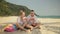 The cheerful love couple holding and eating slices of watermelon on tropical sand beach sea. Romantic lovers two people