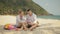 The cheerful love couple holding and eating slices of watermelon on tropical sand beach sea. Romantic lovers two people