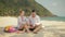 The cheerful love couple holding and eating slices of watermelon on tropical sand beach sea. Romantic lovers two people