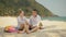 The cheerful love couple holding and eating slices of watermelon on tropical sand beach sea. Romantic lovers two people