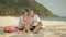 The cheerful love couple holding and eating slices of watermelon on tropical sand beach sea. Romantic lovers two people