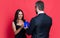 cheerful love couple with present at studio. love couple with present on background.