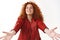 Cheerful lovely dreamy redhead curly-haired woman modern stylish red jacket extend arms close eyes ready kisses hugs