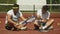 Cheerful male tennis players talking during break