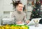 Cheerful man bookkeeper doing paperwork in Christmas decorated office