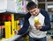 Cheerful man choosing insects killer spray