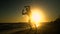 Cheerful man dancing on the beach. He jumps in the sun. The man is having fun. He is happy. Silhouette of a man at