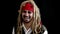 Cheerful man in fancy dress pirate smiling on black background