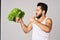 Cheerful man lettuce leaves healthy food posing