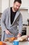 Cheerful man preparing an healthy breakfast in the morning