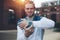 Cheerful man showing his smart watches on the wrist at sunset