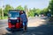 Cheerful man standing by the tuk tuk taxi