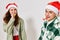 Cheerful man and woman festive pipes Christmas New Year hats fun